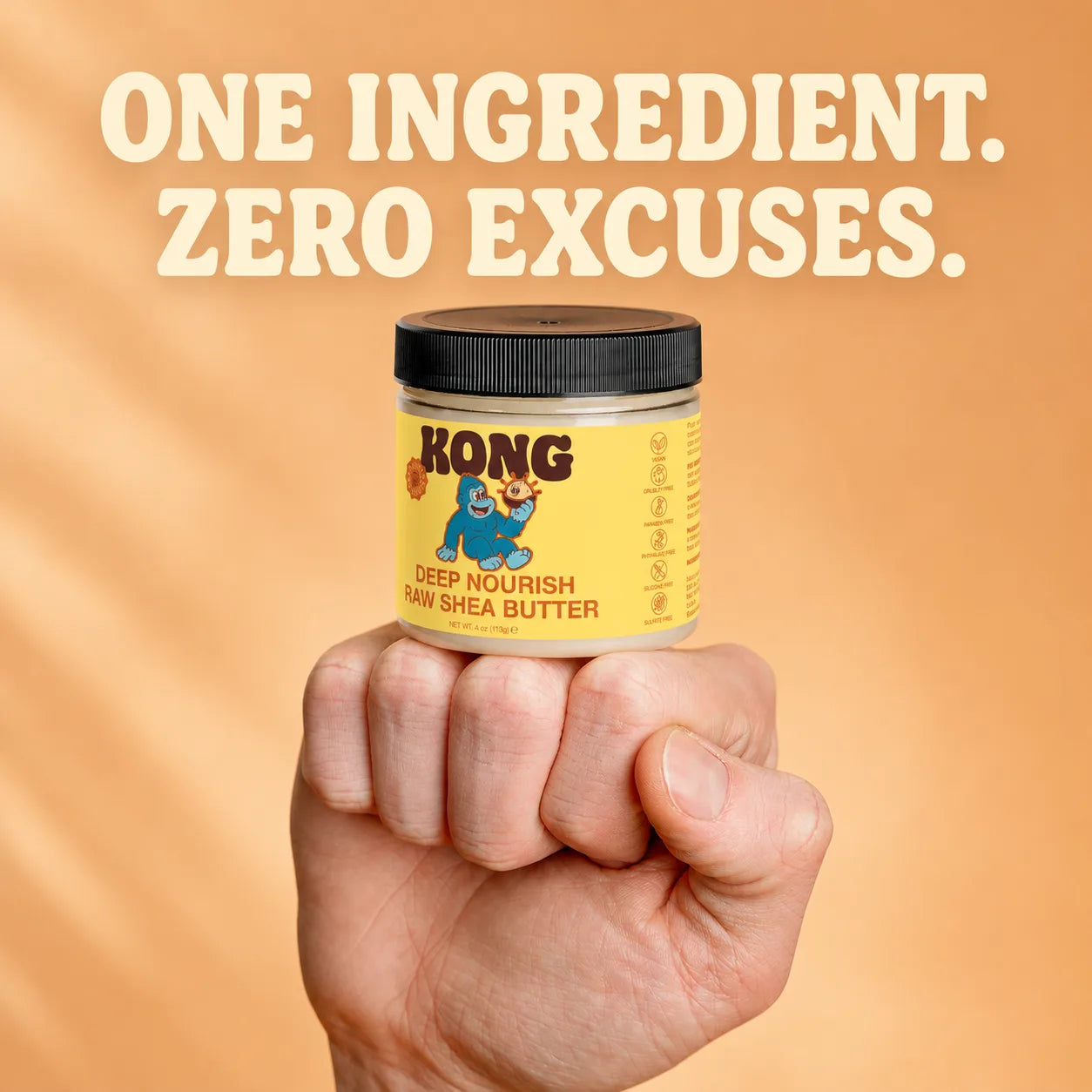 KONG Raw Shea Butter jar held in a fist
